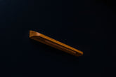 Close-up of a matte finished oak cabinet pull with visible wood grain